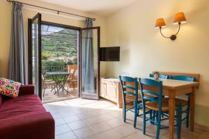 a living room with a couch and a table and chairs at Cefalù Seaside Pool Villa in Cefalù