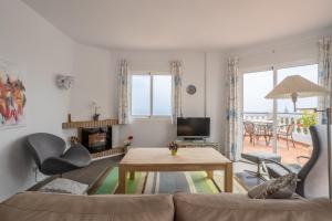 a living room with a couch and a table at Casa Sydhavshytten in Nerja