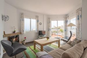 a living room with a couch and a table at Casa Sydhavshytten in Nerja