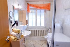 a bathroom with a sink and a toilet and a tub at Heizmannshof in Hofstetten +27 photos