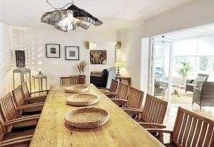 a dining room with a wooden table and chairs at Casa Harriet in Mijas