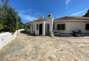 a house with a motorcycle parked in front of it at Casa Harriet in Mijas