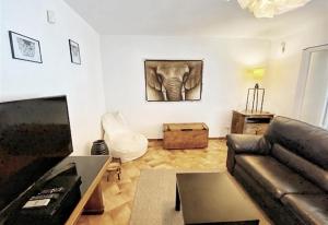 a living room with a couch and an elephant on the wall at Casa Harriet in Mijas