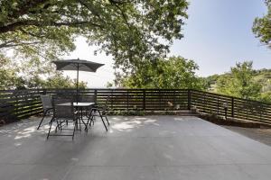 a table and chairs with an umbrella on a patio at Agriturismo Per Caso in Carignano