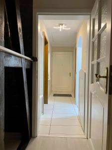 a hallway with a white door and a tile floor at Haus Balke in Hatzfeld +35 photos