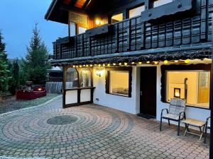 a building with a brick patio in front of it at Haus Balke in Hatzfeld