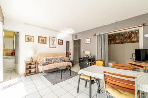 a living room with a couch and a table at Aux Pins Maritimes - A22 in Pornic +14 photos