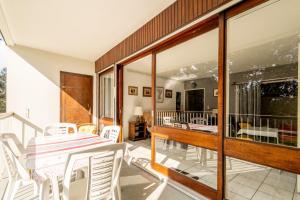 a room with a balcony with a table and chairs at Aux Pins Maritimes - A22 in Pornic