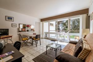 a living room with a couch and a table at Aux Pins Maritimes - A22 in Pornic