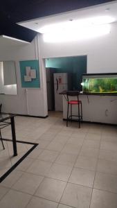 a room with a aquarium and a table and a chair at Alojamiento El Centenario in San Martín