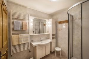 a bathroom with a sink and a shower at Manuel's App Watschinger - Frieda in Sesto +8 photos