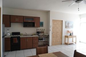 a kitchen with wooden cabinets and a stove top oven at Departamento zona central in La Paz