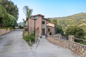 an empty street with a building and a street light at Arcaloro Resort in SantʼAngelo di Brolo