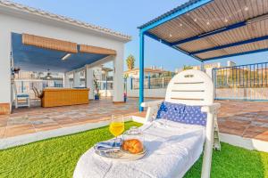 a table with a plate of food and a glass of wine at Villa Mediterraneo in Oliva