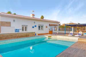 a swimming pool in front of a house at Villa Mediterraneo in Oliva
