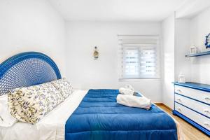 a bedroom with a blue bed and a dresser at Villa Mediterraneo in Oliva +27 photos