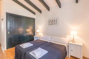 a bedroom with a bed with two night stands and two lamps at Casa 3 O en Complejo Binisafua in Binisafua +25 photos
