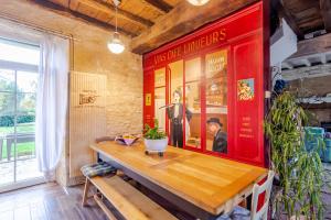 a dining room with a table and a movie poster at Chambres d'hôtes Exotique in Saint-Jory-las-Bloux