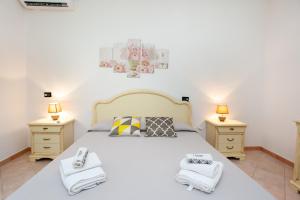 a bedroom with a large bed with two night stands at Casa delle Mimose in Orosei