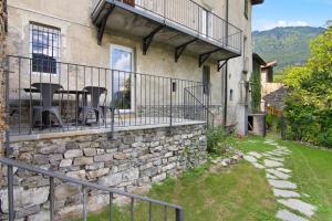 a house with a balcony with chairs and a table at Workation Castle in Carlazzo