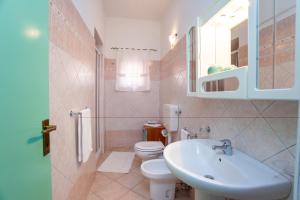 a bathroom with a sink and a toilet at Casa delle Mimose in Orosei