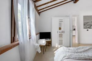 a bedroom with a bed and a desk with a computer at Agriturismo Per Caso in Carignano