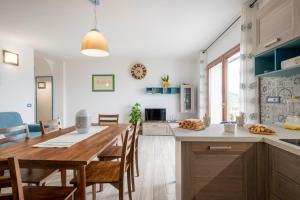 a kitchen with a large wooden table and chairs at Dolcecasa in Dorgali +16 photos