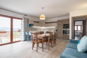 a kitchen and living room with a table and chairs at Dolcecasa in Dorgali