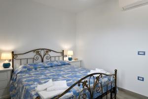 a bedroom with a bed and two night stands at Dolcecasa in Dorgali