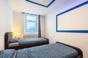 a room with two beds and a projection screen at Gera Apartment in Gera