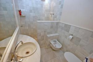 a small bathroom with a toilet and a sink at Sa Portassa in Felanitx +5 photos