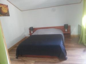 a bedroom with a bed with a black blanket at Maison, Piscine sous les pins in Moliets-et-Maa +26 photos
