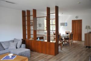 a living room with a couch and a dining room at Rothaarsteig Ferienhaus in Kirchhundem