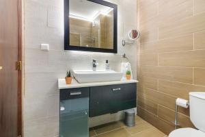 a bathroom with a sink and a mirror at Barbecue and Beach – 200m away in Armação de Pêra +18 photos