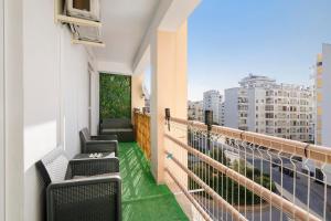 a balcony with chairs and a view of a city at Barbecue and Beach – 200m away in Armação de Pêra