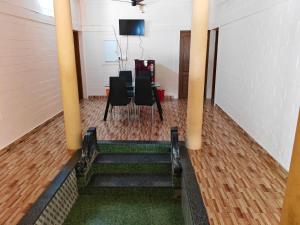 a dining room with black chairs and a table at Quality Inn Resort in Varkala