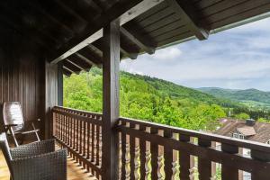 a balcony of a cabin with a view of the mountains at Haus Erichsen in Perlesreut
