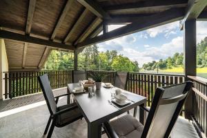 a table and chairs on a balcony with a view at Wiesgut Ferienwohnung Golden in Tesimo