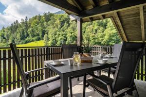 a table and chairs on a balcony with a view at Wiesgut Ferienwohnung Golden in Tesimo
