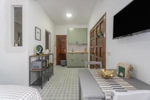 a living room with a tv and a kitchen at Studio Tagoro in Guía de Isora +19 photos
