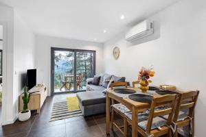 a living room with a table and a couch at Gerês Hideaway in Vilar da Veiga