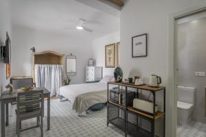 a bedroom with a bed and a desk and a bathroom at Studio Tagoro in Guía de Isora