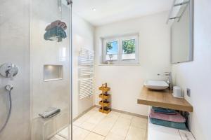 a bathroom with a shower and a sink at Haus Regina in Löffingen +18 photos
