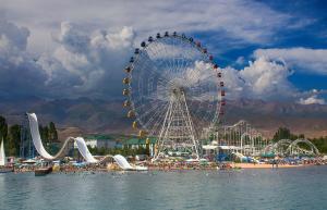 a ferris wheel at a carnival on a beach at Эдем ИссыкКуль in Bosteri