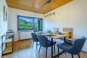 a dining room with a table and chairs at Brandenkopfblick in Oberharmersbach