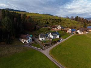an aerial view of a village with houses and a road at Brandenkopfblick in Oberharmersbach