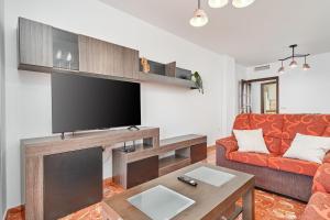 a living room with a television and a couch at Casa Axarquia 2 in Vélez-Málaga +17 photos