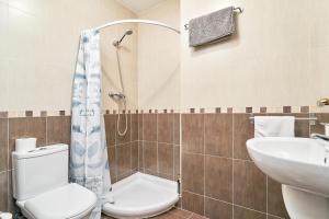 a bathroom with a toilet and a sink at Casa Axarquia 2 in Vélez-Málaga