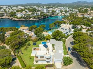 an aerial view of a large white house and a river at Mon Obert Cala Serena in Felanitx