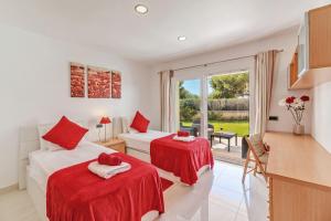 a room with two beds and a kitchen with a window at Mon Obert Cala Serena in Felanitx +24 photos